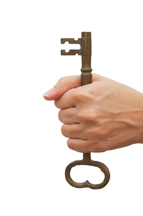 Woman holding a skeleton key over white background