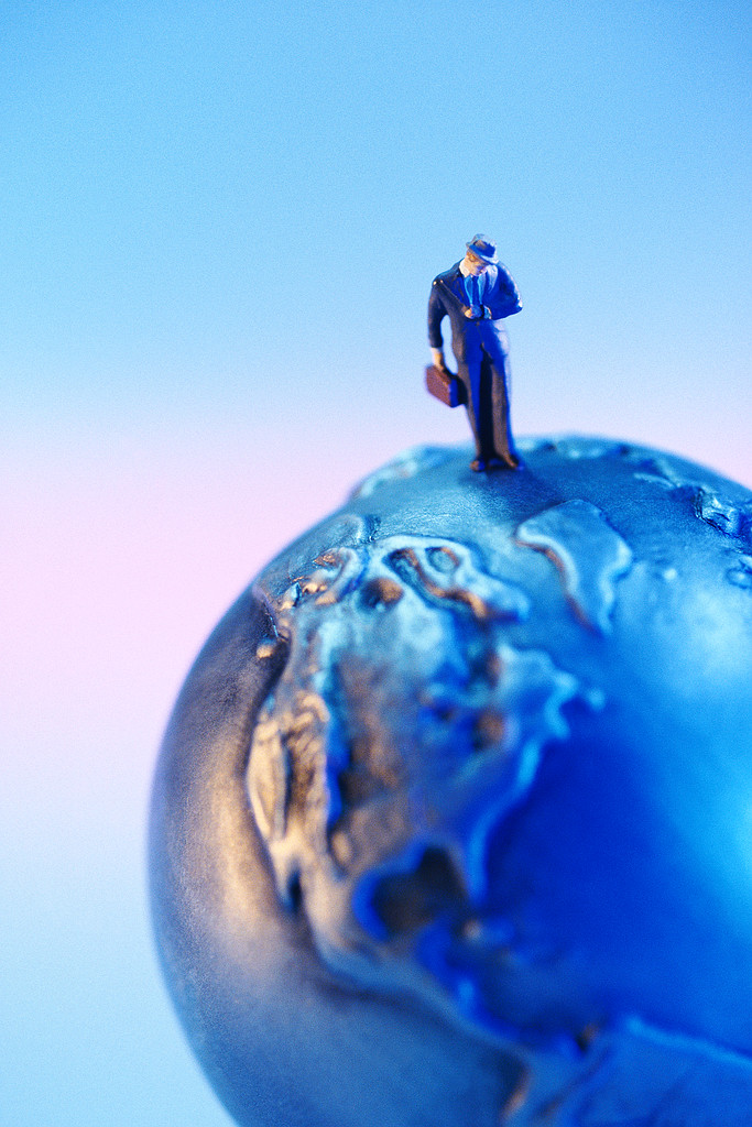 Businessman Standing on Globe