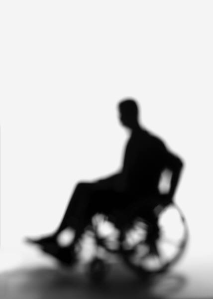 silhouette of man on a wheelchair