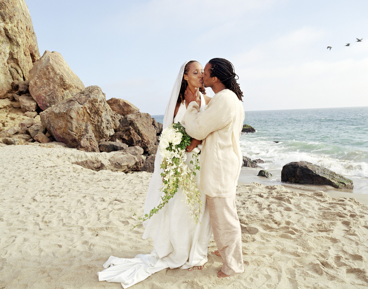 Newlyweds kissing on the Beach
