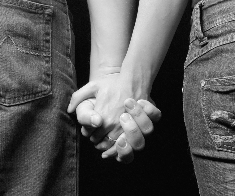 engaged couple holding on hands