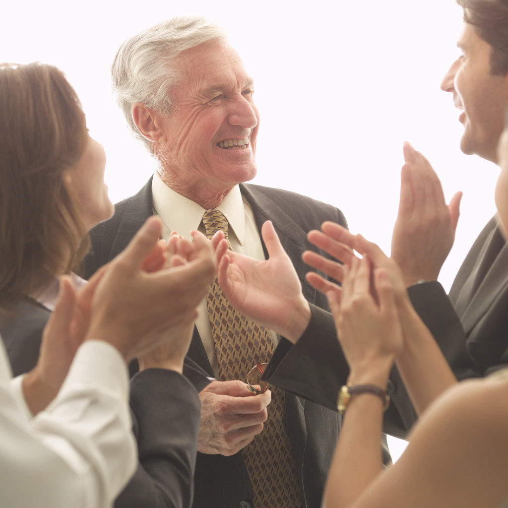 Colleagues Applauding Senior Businessman