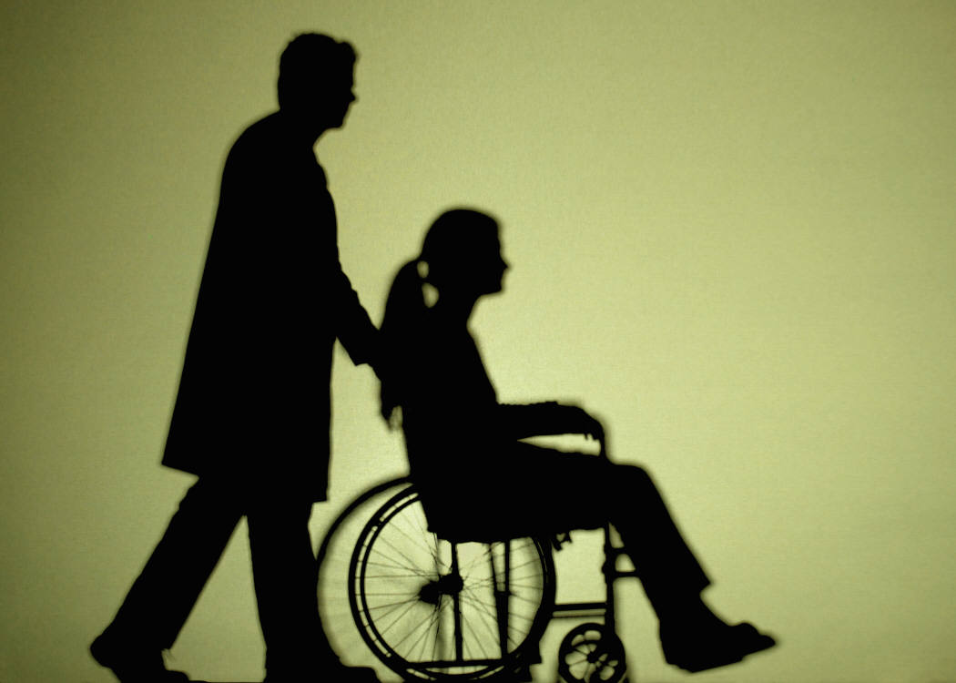 man assisting a woman on a wheelchair