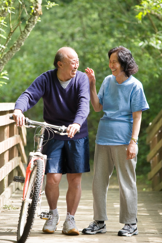 A couple senior asian talking and exercising at a park