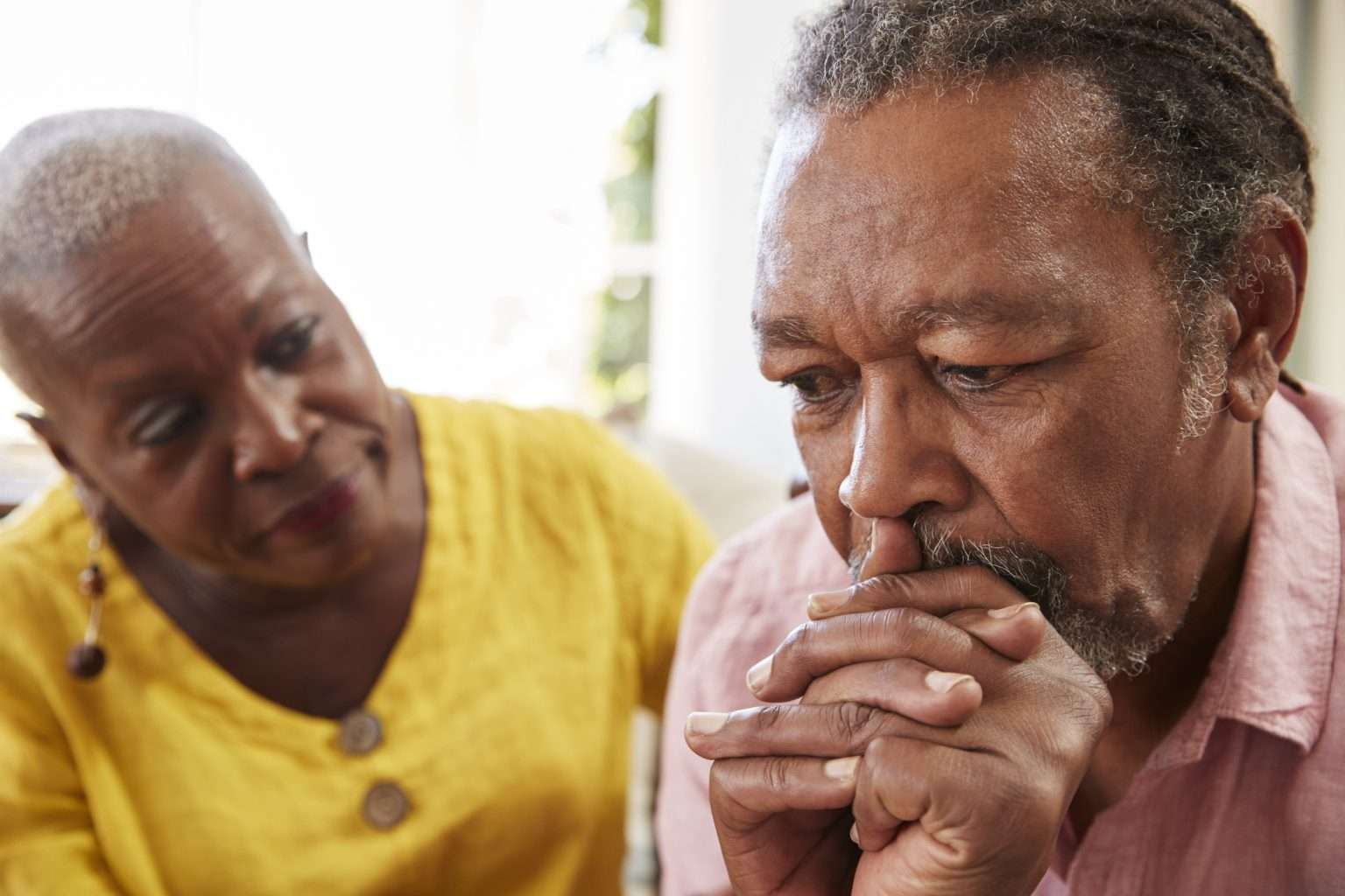 Senior woman comforting man with Dementia at home