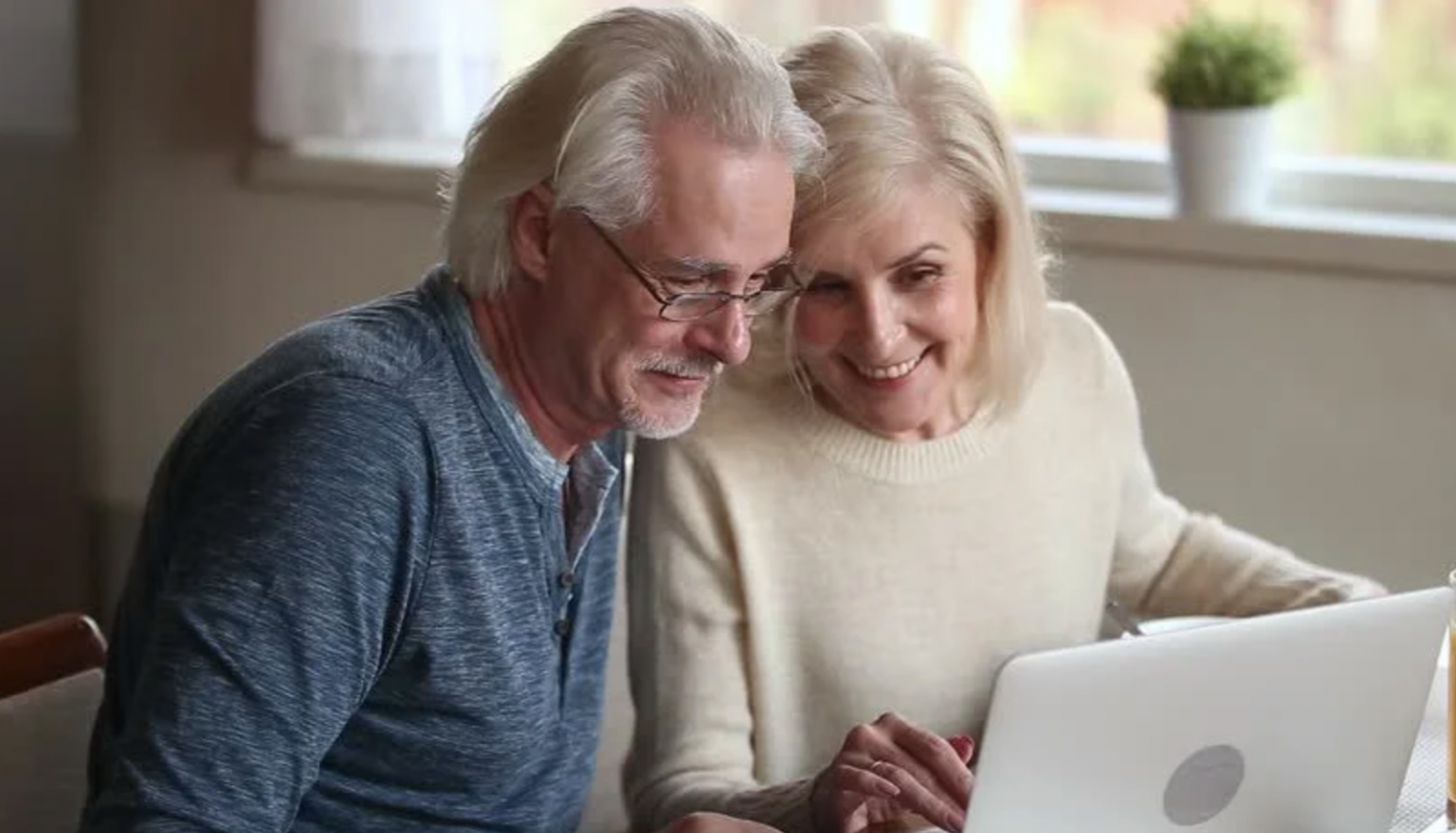 elderly couple using laptop