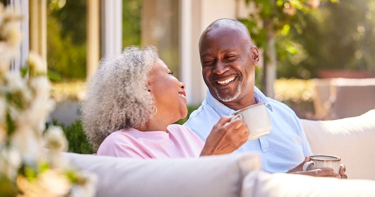 husband and wife smiling