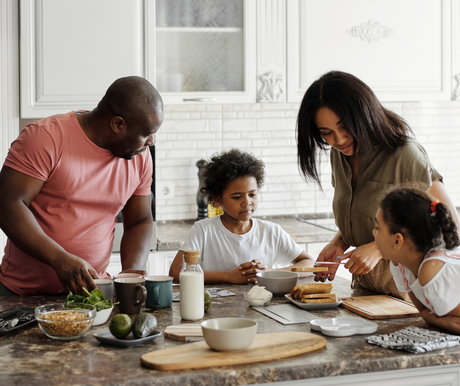 Living trust concept: a young family preparing breakfast in the kitchen