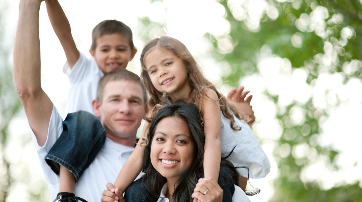 Equal inheritance concept: photo of husband and wife with their young children outside